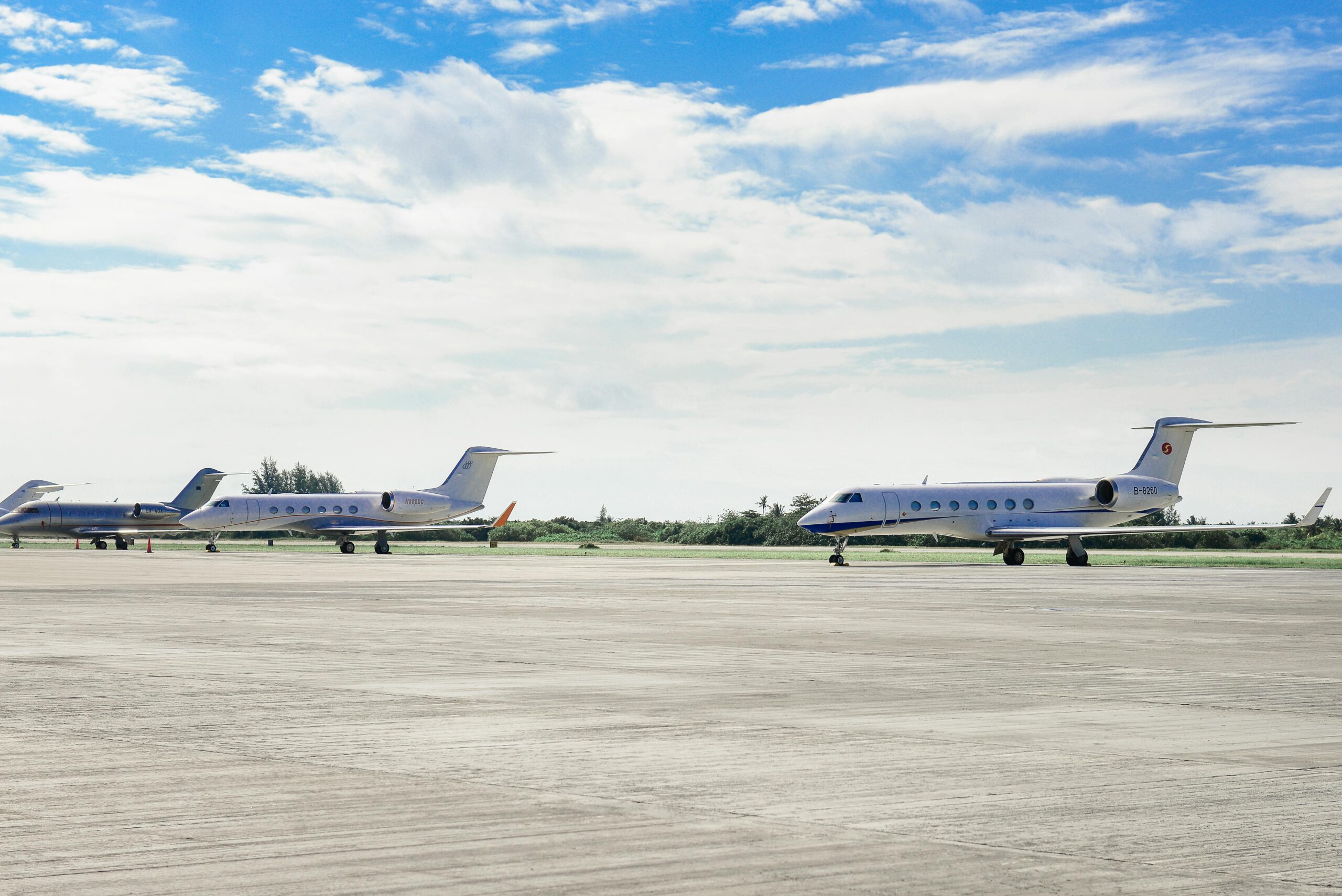 Two private planes on an airport tarmac. Photo by Asad Photo Maldives: https://www.pexels.com/photo/three-parked-airplanes-2245279/